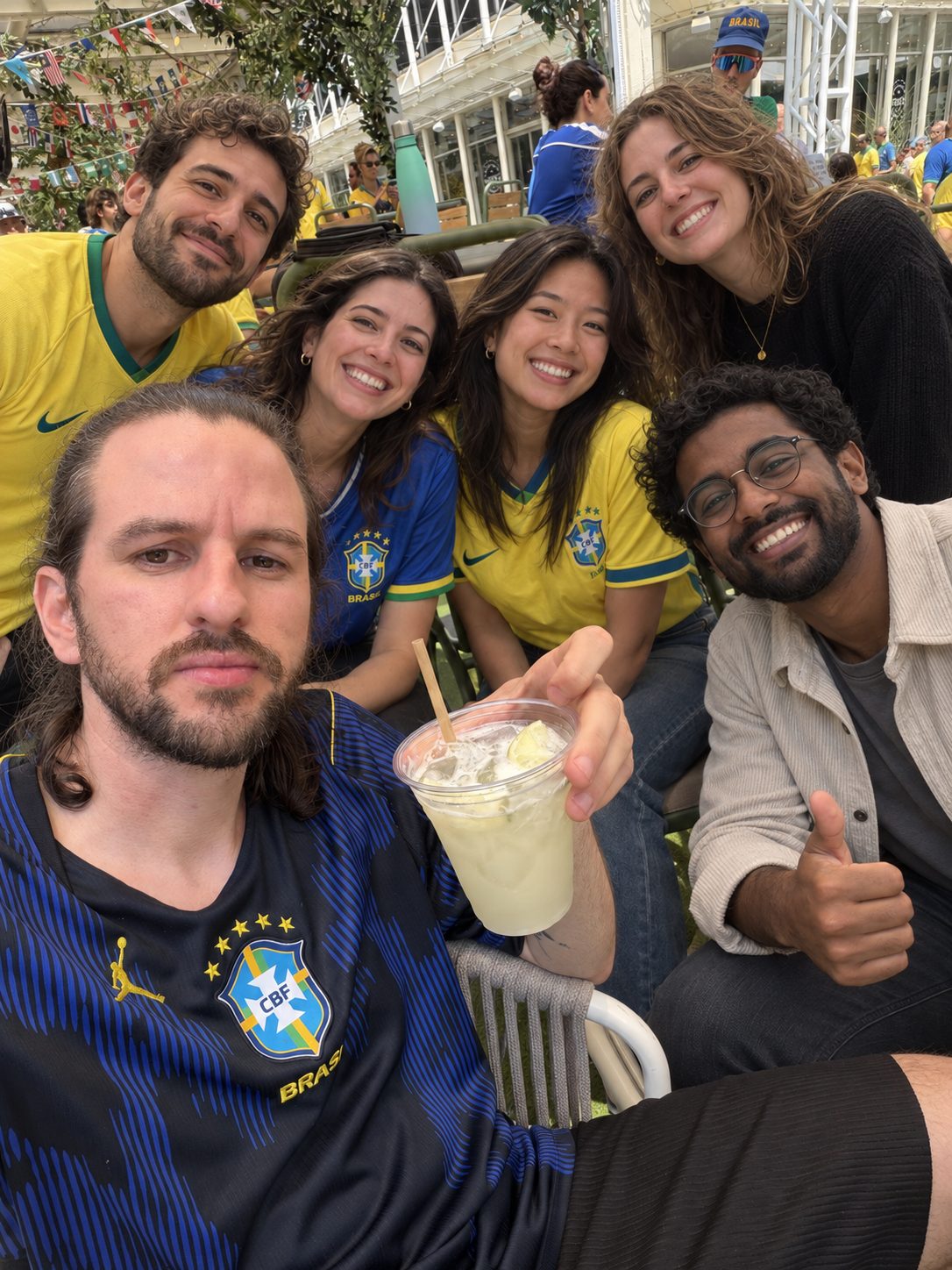 The 2FLY team in Brazil jerseys watching the game